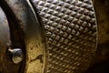 A macro, extreme close up of a hand toolÃ¢â¬â¢s metallic, textured surface.